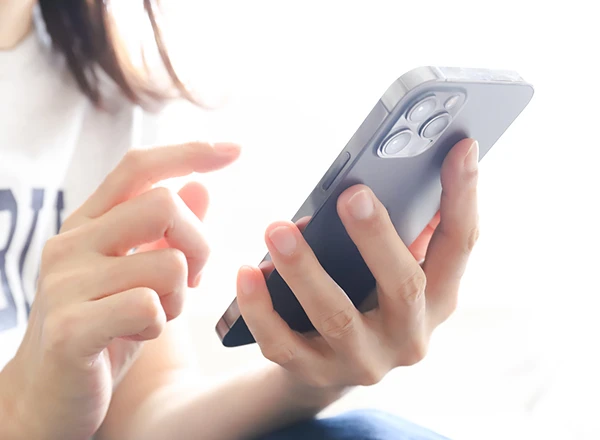 スマートフォンを操作する女性の手